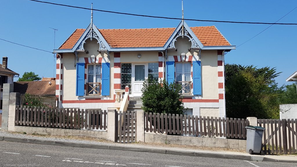 Small old house with red and white boarders