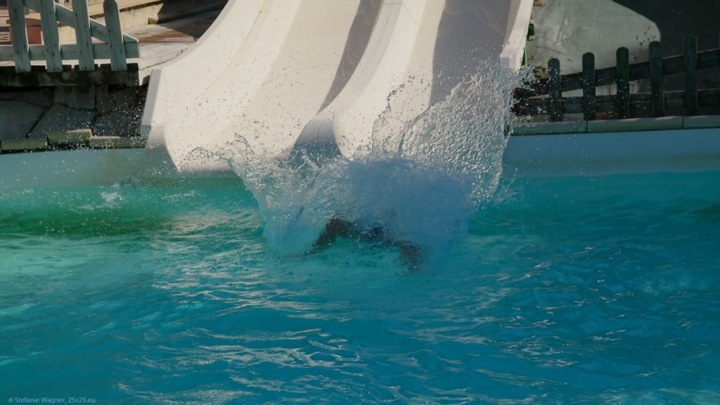 End of a slide with water splashing