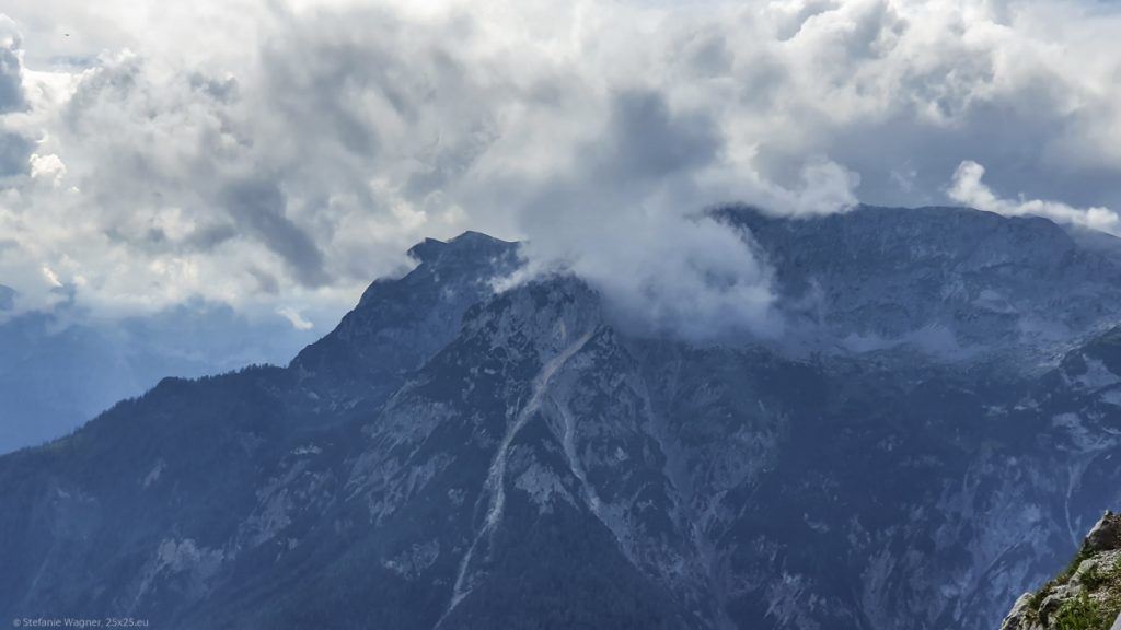 A mountain in a distance, covered partially by clouds