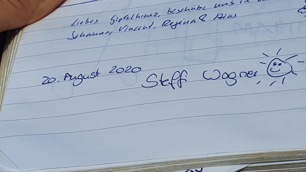 My entry into the summit book with the date, the name and a smiling sun