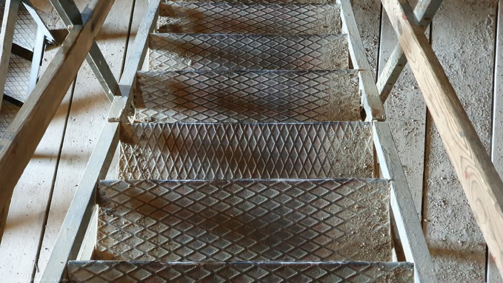 Stairs with diamond shapes on them, only one step with a different orientation