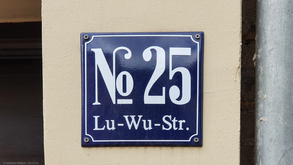 Blue sign with white letters saying "No 25 Lu-Wu-Str."