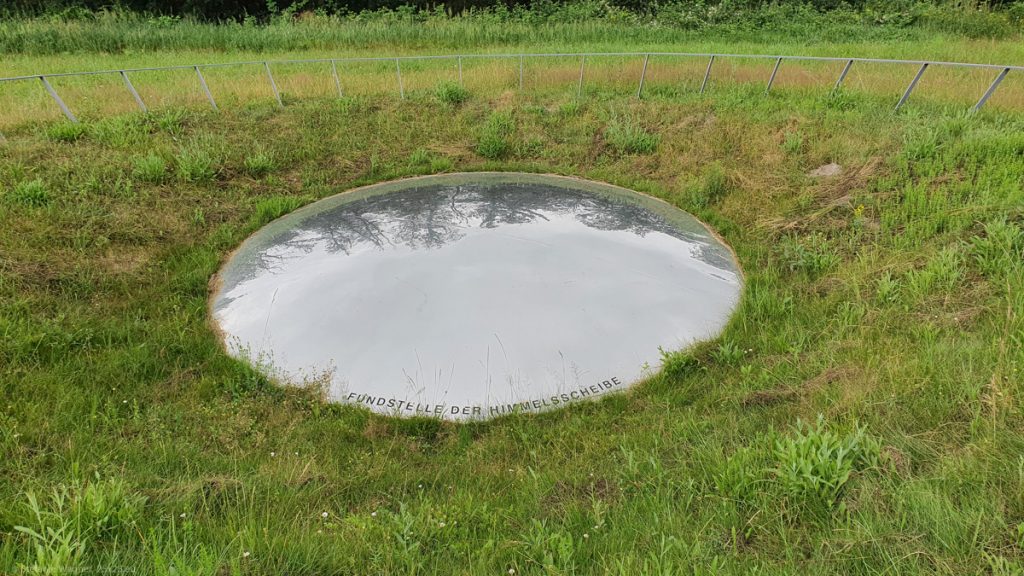 Big mirror like circle on green gras in a hollow