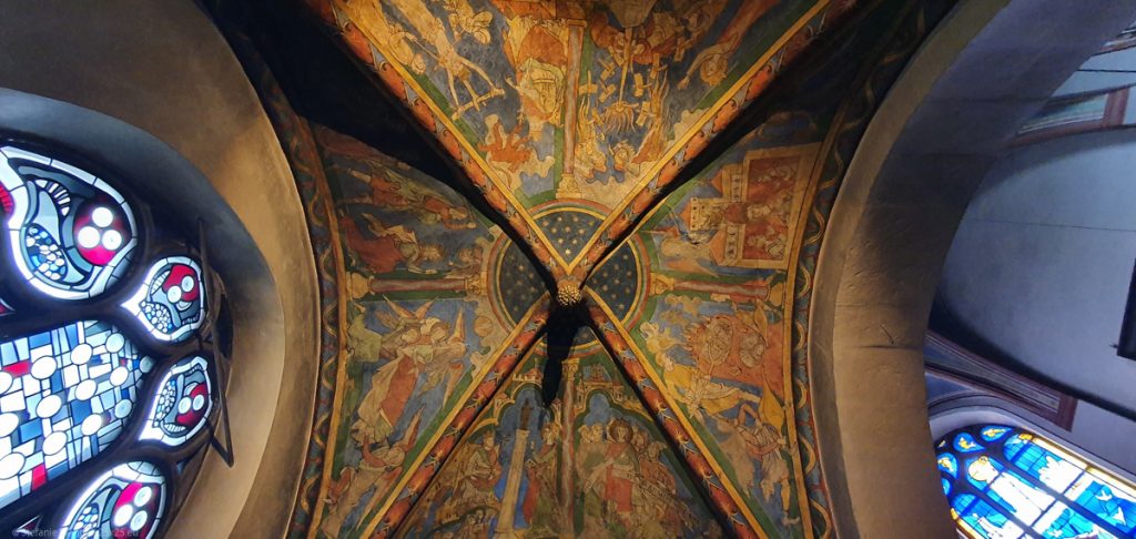Colorful ceiling with blue, red, and yellow church paintings