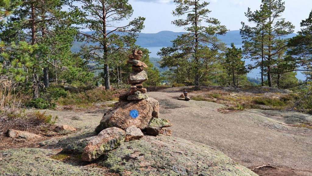 Stone figures created by stacking stones, big stone with a big blue dot
