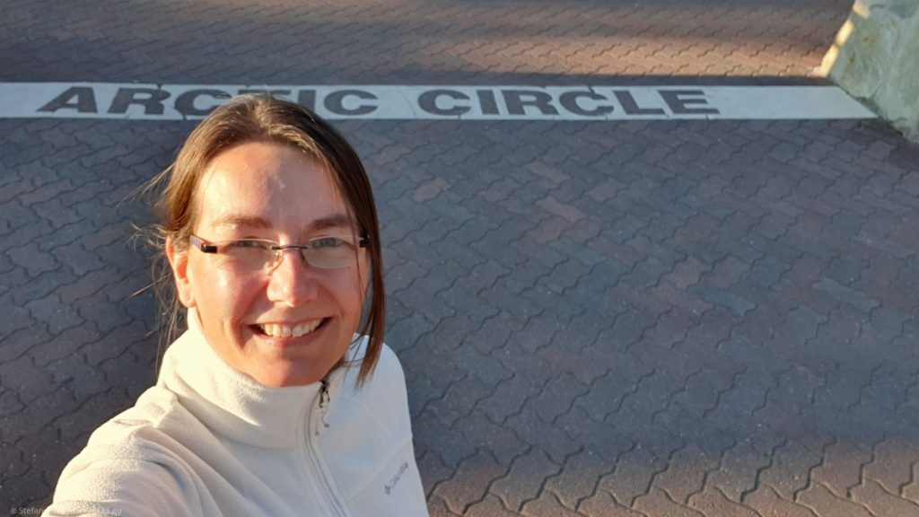 Selfie with the white line in the background saying "Arctic Circle"