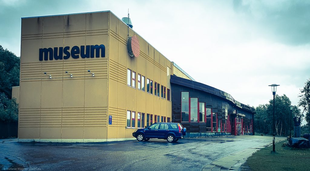 Modern, yellow, two story building with the word "museum" in big letters