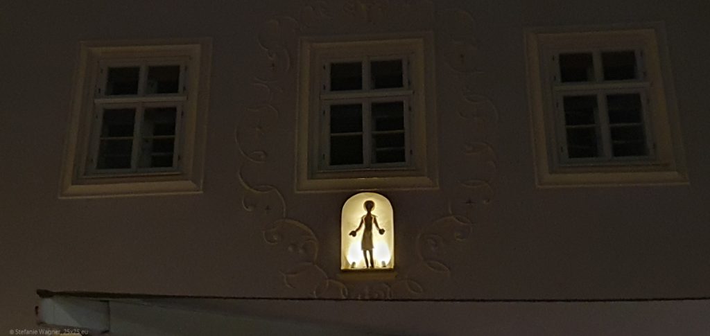 Night, house in the dark, backlit figure